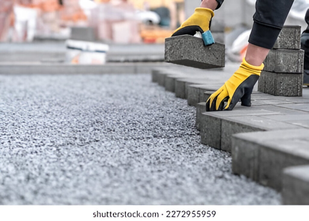 laying interlocking pavers during construction 260nw 2272955959
